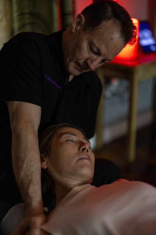 Dr. Bumgarner treating a patient at home with dramatic warm lighting